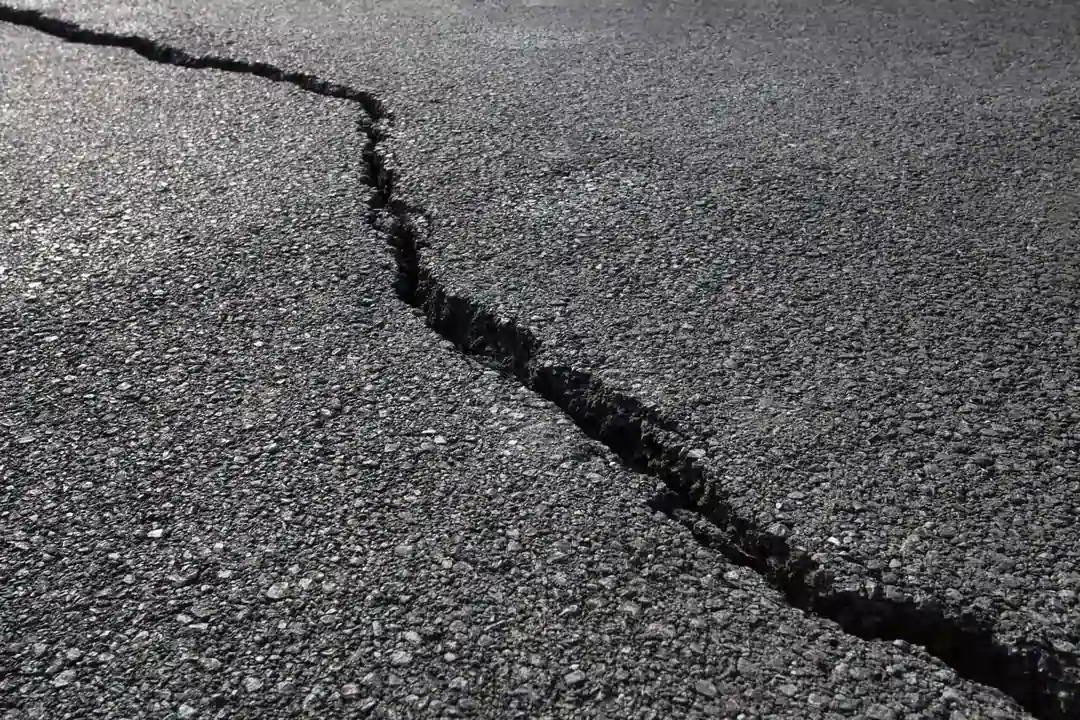 Large crack in asphalt pavement