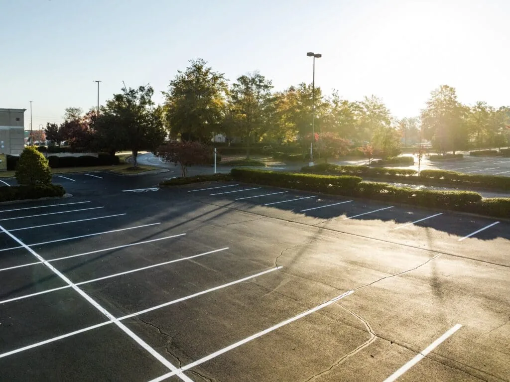 Sun shining down over freshly striped parking lot