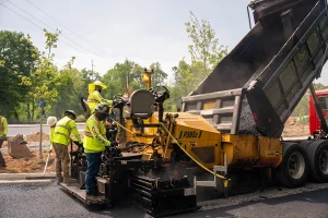 A group of Blackjack Paving technicians performing asphalt paving service.